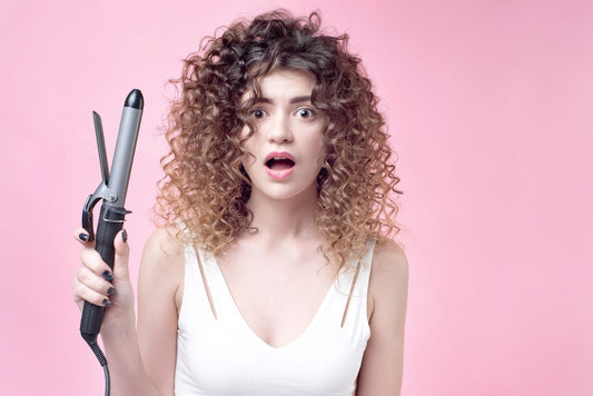 girl posing surprised with a L'ange Flat iron 